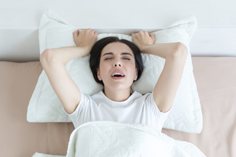 Mi az orgazmus? A beautiful woman lies in bed, enjoys an orgasm, alone at home