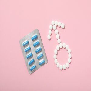 A pack of blue viagra pills with a male sign