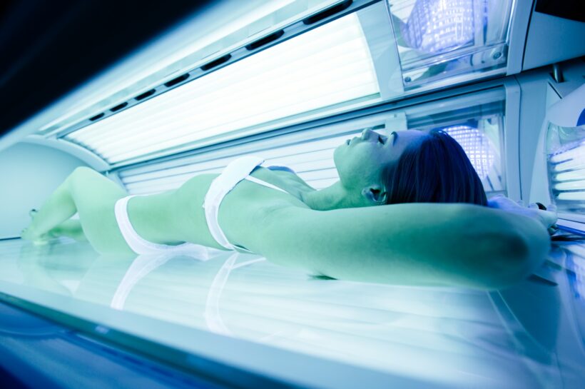 Beautiful woman lying in solarium