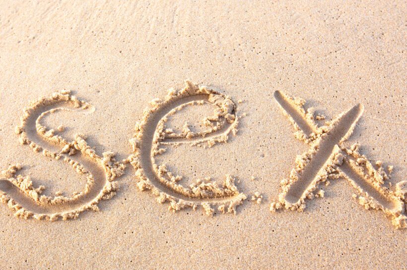 word "sex" written on beach sand